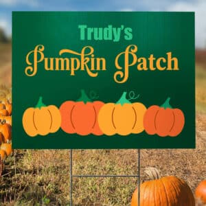 Custom printed coroplast yard sign for "Trudy's Pumpkin Patch" displayed in an autumn field.